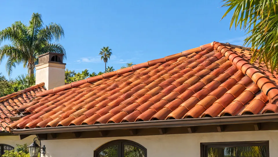 A new terracotta clay tile roof under a blue sky