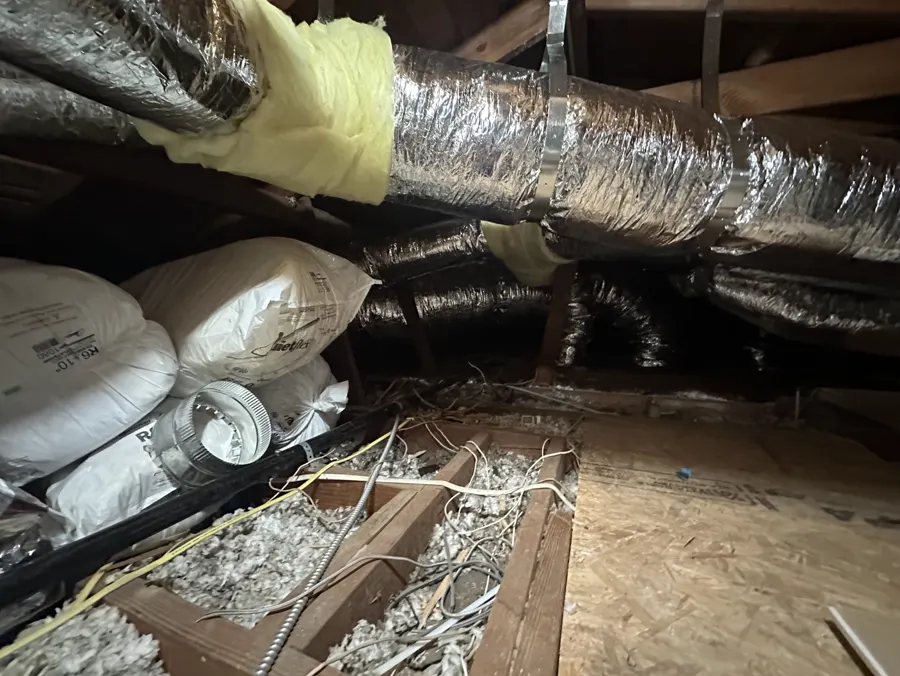 Insulated flexible ductwork running across an attic