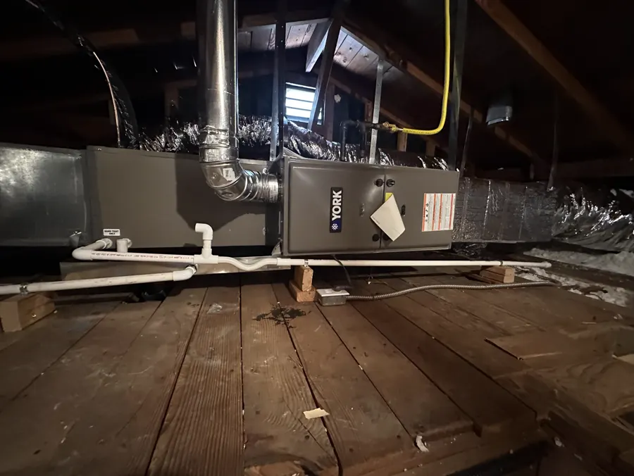 A furnace and ductwork in an attic