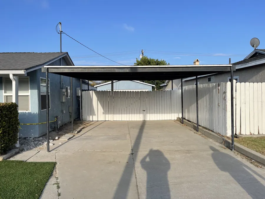 A new concrete slab under a carport