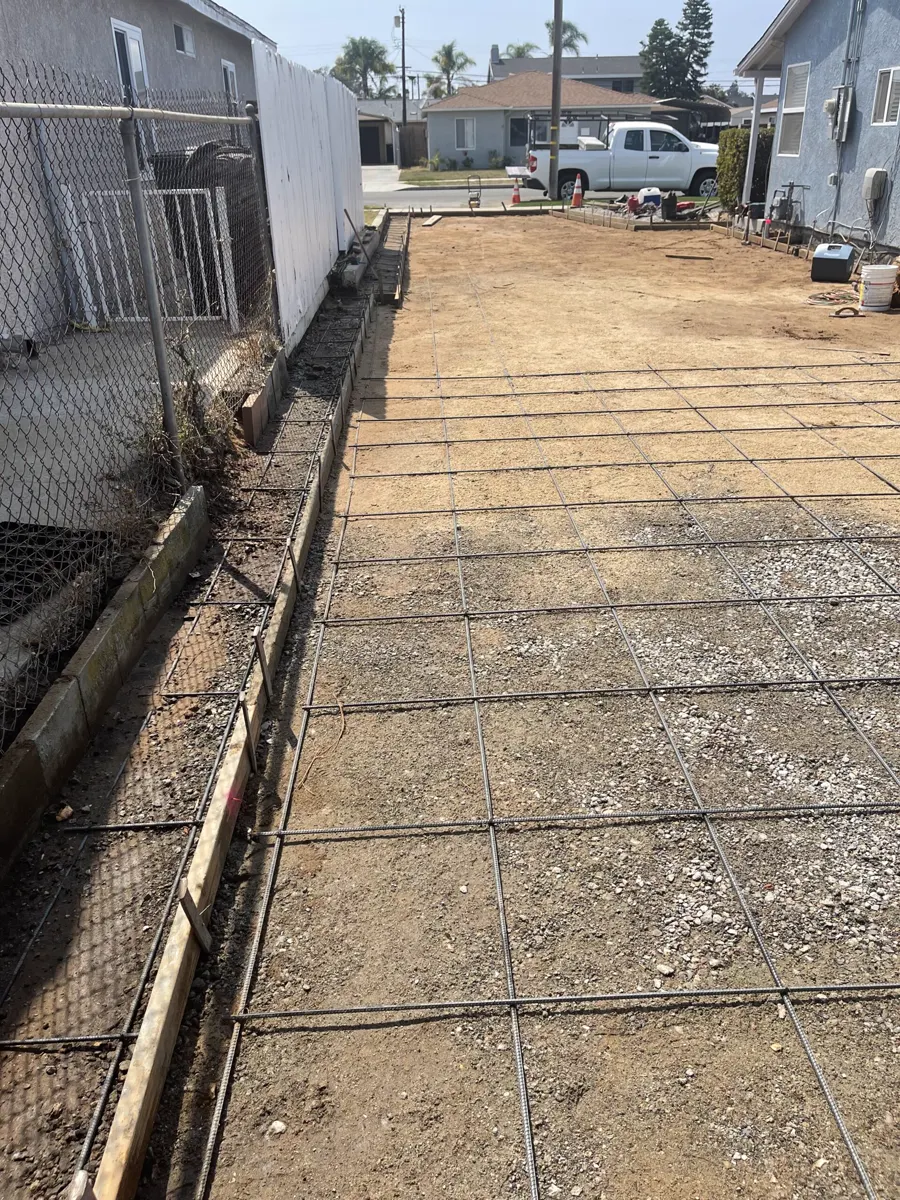 A side yard formed up, with a rebar grid over base rock