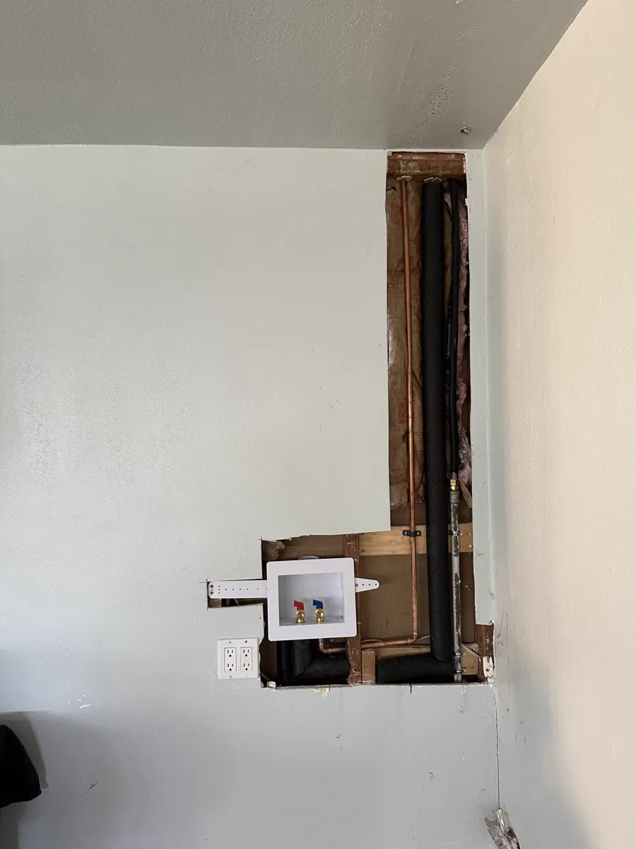 A new washing machine outlet box and copper lines in an opened wall