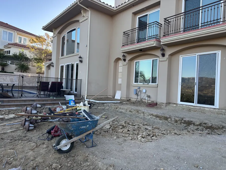 The bare dirt yard of the same house, graded for base rock